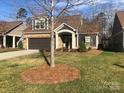 Charming home with a stone facade, covered entryway, two-car garage, and well-maintained landscaping at 1220 Avalon Pl, Matthews, NC 28104