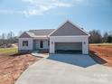 A new construction home is shown with an attached garage and concrete driveway at 1282 Beal Rd, Lincolnton, NC 28092