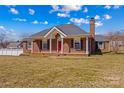 Traditional one-story brick home with a bright red door and a neatly kept front yard at 130 Ketchie Dr, Mooresville, NC 28115
