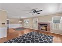 Cozy living room with a brick fireplace, hardwood floors, and ample natural light at 130 Ketchie Dr, Mooresville, NC 28115
