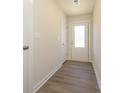 A bright hallway features wood-look flooring, a white door with glass pane, and neutral paint at 1307 Cerium Way, Charlotte, NC 28211