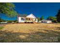 Inviting home with a front porch, complemented by a spacious lot and detached garage at 1311 Mack Dr, McConnells, SC 29726