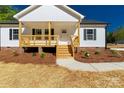 Close up of the front porch, featuring natural wood steps and charming details at 1311 Mack Dr, McConnells, SC 29726