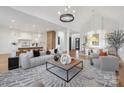 Open-concept living area showcases contemporary design with a decorative rug and seamless flow to the kitchen and dining at 144 Sardis Ln, Charlotte, NC 28270