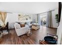 Spacious living area featuring hardwood floors, a large sofa and a sliding glass door at 1461 Forkhorn Dr, Monroe, NC 28110