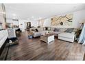 Open-concept living room features hardwood floors, a large sectional, and stylish decor at 1461 Forkhorn Dr, Monroe, NC 28110