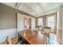 Bright study with coffered ceiling, natural light, and doorway view to the foyer at 2027 Gloucester St, Matthews, NC 28104