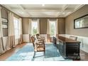 Elegant study with coffered ceiling, hardwood floors, and large windows offering ample light at 2027 Gloucester St, Matthews, NC 28104