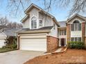 Charming two-story home featuring a brick and gray siding exterior, attached garage and well-maintained walkway at 2027 Meadowood Ln, Charlotte, NC 28211