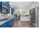 Modern kitchen with stainless steel appliances, granite countertops, and a view of the adjacent dining area at 2174 Black Forest Cv, Concord, NC 28027