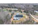 A sprawling aerial view showcases the stunning property with its modern farmhouse, nestled in a picturesque landscape at 2288 Boheler Rd, Clover, SC 29710