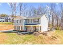 Stylish two-story home featuring stone accents, landscaped yard, and a cozy front porch at 247 Reese Wilson Rd, Belmont, NC 28012