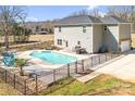 Backyard featuring a private in-ground pool, patio area, outdoor seating and dining, and a lush green lawn at 247 Reese Wilson Rd, Belmont, NC 28012