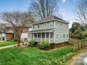 Inviting two-story home featuring a spacious front porch and lush green lawn at 2729 Duncan Ave, Charlotte, NC 28205
