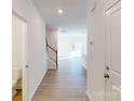 Bright hallway featuring wood floors, staircase with white railing, and recessed lighting at 3562 Nimbell Rd, Monroe, NC 28110