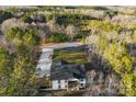 Expansive aerial view showcasing the home's wooded surroundings and long driveway at 40934 Deer Haven Dr, Albemarle, NC 28001