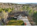 Aerial view of a well-maintained home with a long driveway and expansive, tree-filled surroundings at 40934 Deer Haven Dr, Albemarle, NC 28001