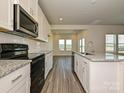 Modern kitchen featuring stainless steel appliances, granite countertops, and ample cabinet space at 459 Olympia Way, York, SC 29745