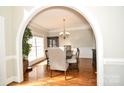 Elegant dining room with hardwood floors, chair rail, and archway entrance at 4812 Campobello Dr, Monroe, NC 28110
