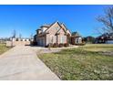 Spacious three-car garage and extra parking pad on large lot with mature trees at 4812 Campobello Dr, Monroe, NC 28110