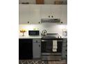 Well-equipped kitchen with stainless steel appliances, white cabinets, and bright countertops at 5702 Burning Ridge Dr, Monroe, NC 28110