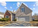 Two-story home showcasing a two-car garage and well-manicured landscaping at 5720 Parkstone Dr, Matthews, NC 28104