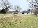 Expansive backyard featuring mature trees and ample space for outdoor activities at 601 Apple St, Gastonia, NC 28054
