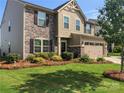 Traditional-style home with manicured lawn, detailed trim, and a two-car garage at 6112 Canyon Trl, Denver, NC 28037