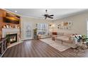 Cozy living room with fireplace, plush sofa, and door to the outdoor patio at 653 Camrose Ne Cir, Concord, NC 28025