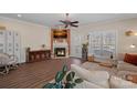 Bright living room boasting a fireplace, hardwood floors, and a large window at 653 Camrose Ne Cir, Concord, NC 28025