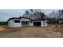 Modern home with white siding, black trim, and an attached garage, ready for move-in at 6855 Union Rd, Gastonia, NC 28056
