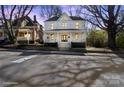 Charming two-story home with a welcoming front porch, enhanced by mature trees and a well-maintained lawn at 85 Grove Nw Ave, Concord, NC 28025