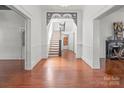Grand foyer featuring hardwood floors, staircase, and decorative archway at 85 Grove Nw Ave, Concord, NC 28025