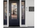 Elegant front door with decorative glass panels, sidelights, and a modern mailbox, creating a stylish entrance at 85 Grove Nw Ave, Concord, NC 28025