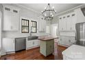 Modern kitchen with white cabinets, stainless steel appliances, and wooden island at 85 Grove Nw Ave, Concord, NC 28025