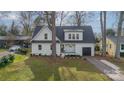 Beautifully landscaped home with a modern exterior, lush green lawn, and newly paved driveway at 908 Stanfield Dr, Charlotte, NC 28210