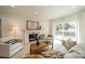 Bright living room featuring a cozy fireplace, stylish furniture, and sliding doors to the deck at 908 Stanfield Dr, Charlotte, NC 28210
