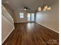 Spacious living room with hardwood floors, ceiling fan, and access to the backyard at 122 Barnhardt Loop, Mooresville, NC 28117