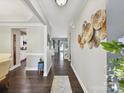 Elegant entryway with hardwood floors and decorative wall art, leading to various rooms at 16404 Mckee Ridge Dr, Charlotte, NC 28278