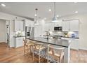 Modern kitchen features a large center island with bar seating, stainless steel appliances, and ample cabinet space at 18010 Aura Mist Way # 178, Huntersville, NC 28078