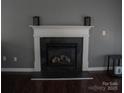 Elegant white fireplace mantel with decorative details, creating a cozy focal point at 1906 Bromwich Rd # B, Charlotte, NC 28208