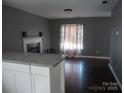 Open-concept living room with fireplace, modern paint, and ample natural light at 1906 Bromwich Rd # B, Charlotte, NC 28208