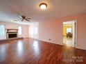 Bright living room features a cozy fireplace, wood floors, and access to the dining area and backyard at 2623 Shaw Ave, Gastonia, NC 28054