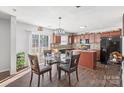 Bright eat-in kitchen featuring wood floors, stainless appliances, and sliding glass door to outdoor space at 3428 Orr St, Charlotte, NC 28269