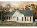 Charming single-story home with a covered porch and a well-maintained lawn at 580 Earley St, Kannapolis, NC 28083