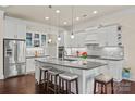 Modern kitchen with white cabinets, granite countertops, and a large center island at 615 Bourton House Dr, Charlotte, NC 28211