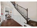 Beautiful staircase with dark wood treads and decorative iron railings at 615 Bourton House Dr, Charlotte, NC 28211