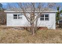 Street view of a small, white brick home with an aged front yard in need of some love and attention at 6230 Old Mocksville Rd, Salisbury, NC 28144