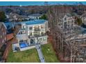 Modern home featuring multiple balconies, a pool, and a stairway to the yard at 7111 Anchorage Ln, Tega Cay, SC 29708
