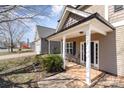 Inviting covered front porch featuring white columns and a cozy seating area at 757 Jones Branch Rd, Fort Mill, SC 29715